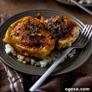 Cooked chicken thighs on cauliflower rice