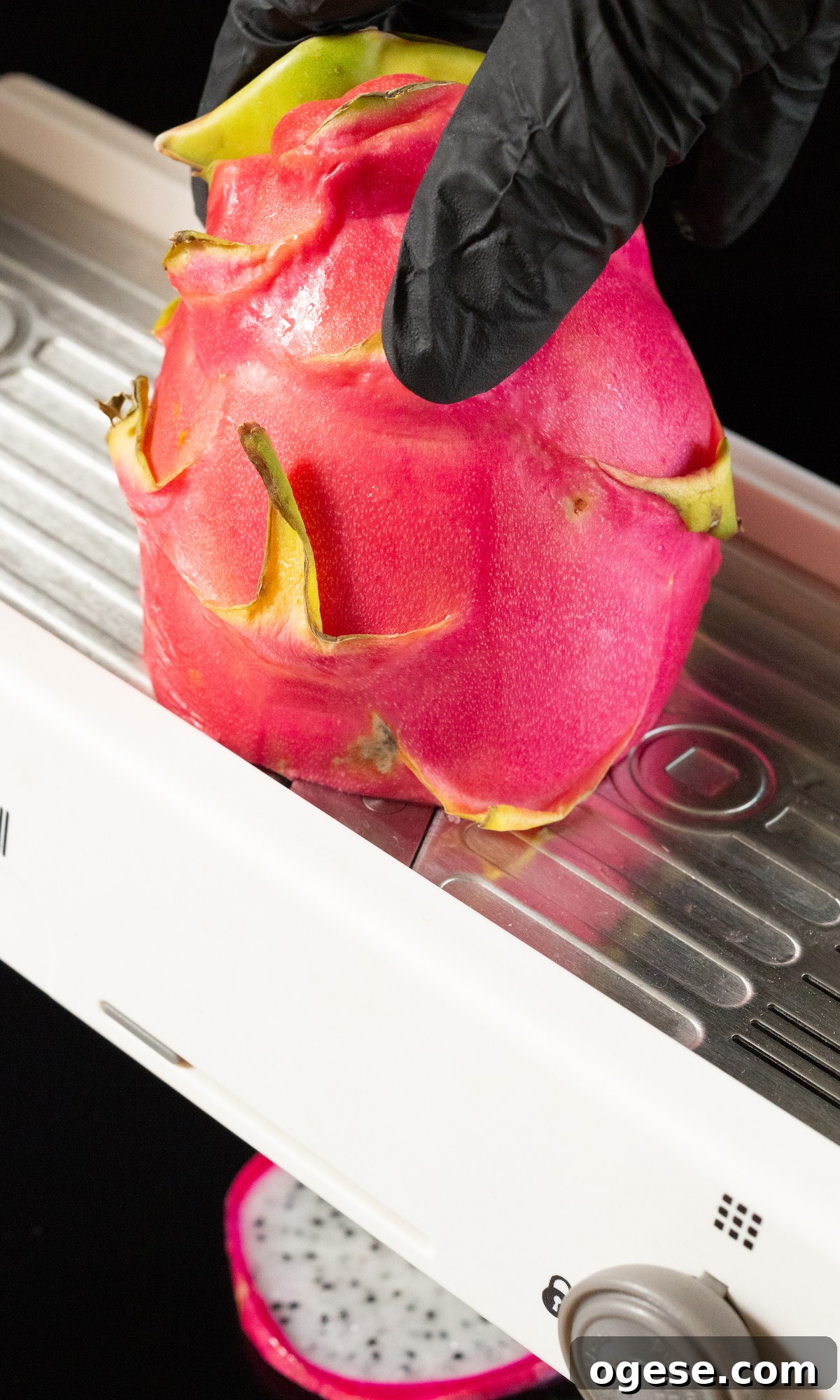 Dehydrated Dragon Fruit Chips: DIY Recipe and Storage Tips 4 A pink peel dragonfruit being sliced on a mandoline.