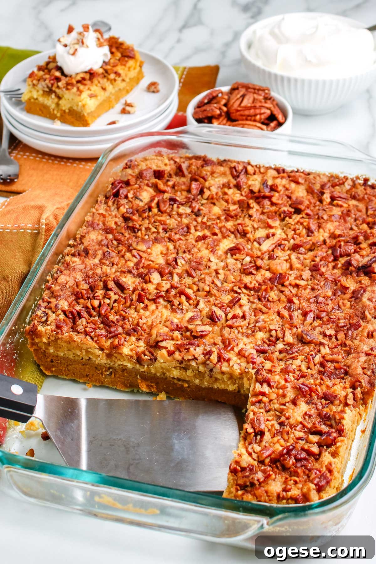 A spatula in the casserole dish with the pumpkin dump cake. 