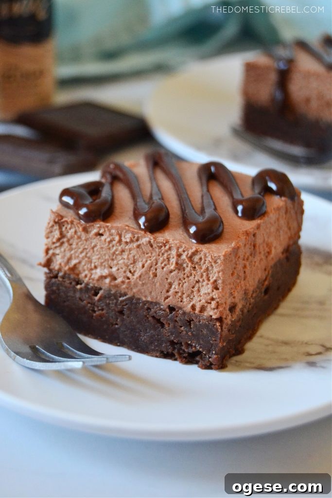 Baileys Chocolate Mousse Brownies Recipe 4 A square of a Bailey's chocolate mousse brownie on a white plate
