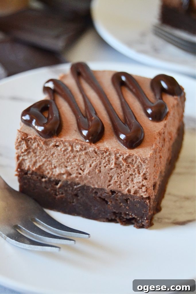 Baileys Chocolate Mousse Brownies Recipe 6 Closeup slice of a bailey's mousse brownie on a white plate