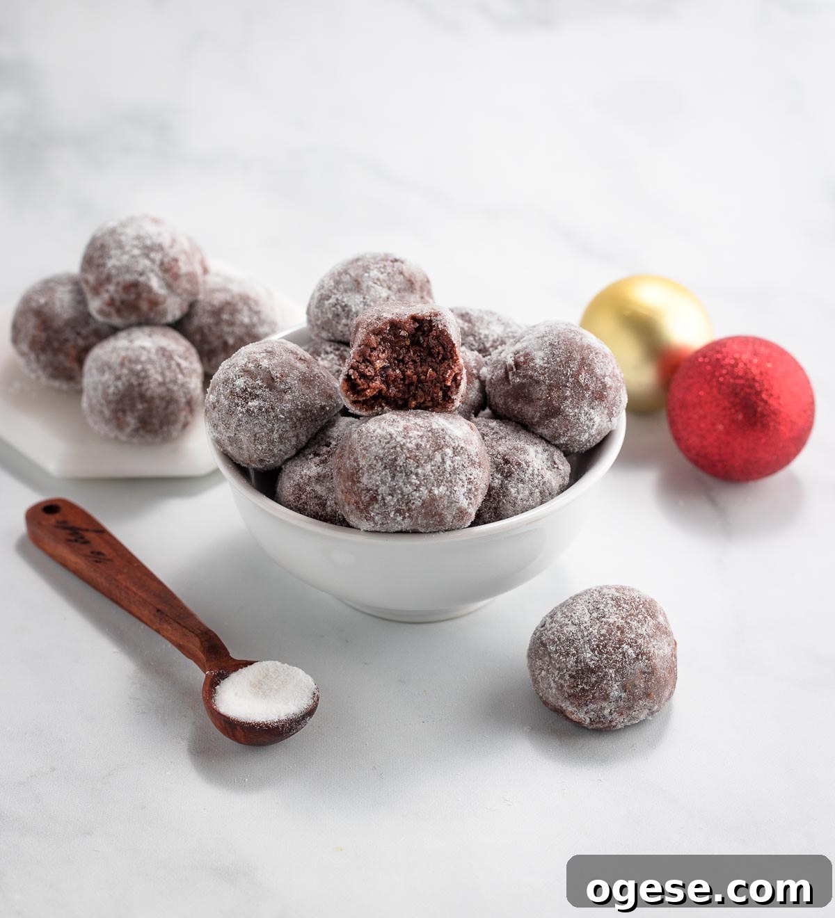 A bowl of keto muddy buddy balls with one ball having a bite in it.