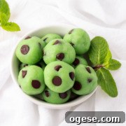 keto mint chocolate chip cheesecake bites in a bowl with mint leaves.
