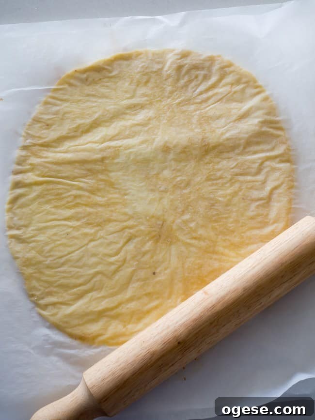 Rolling fathead dough between parchment paper