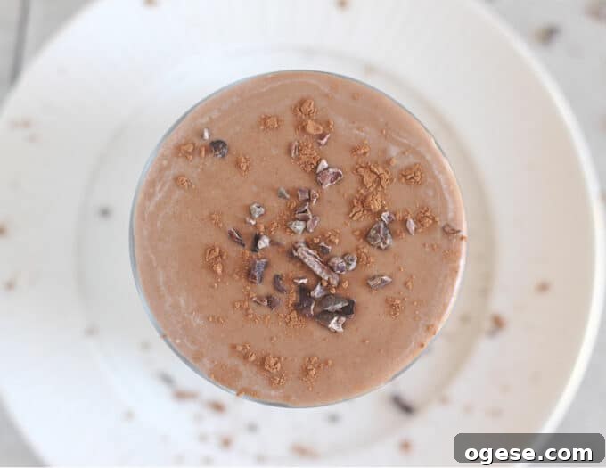 Creamy Chocolate Peanut Butter Banana Smoothie 7 Top down view of a chocolate smoothie with cacao nibs on top.