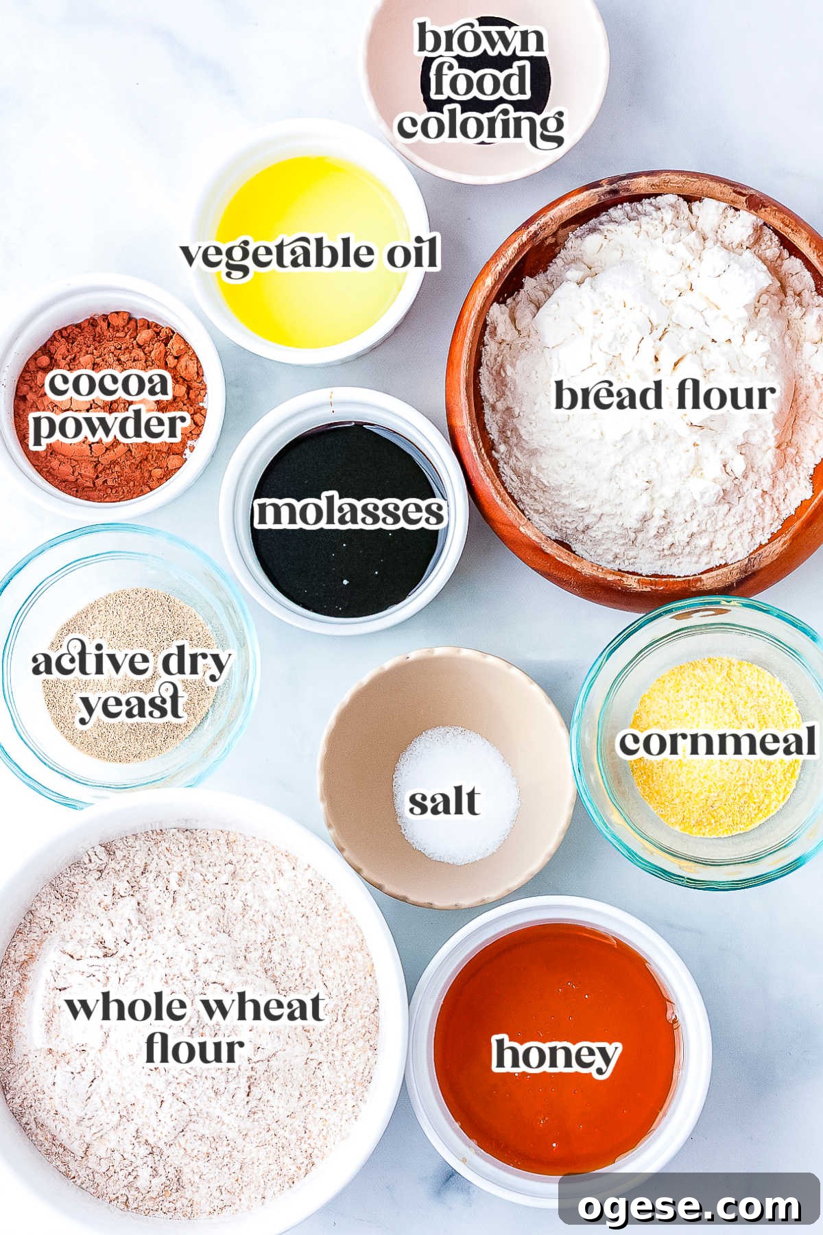 Ingredients for copycat Outback bread including whole wheat flour, bread flour, cocoa powder, honey, molasses, yeast, vegetable oil, and cornmeal.