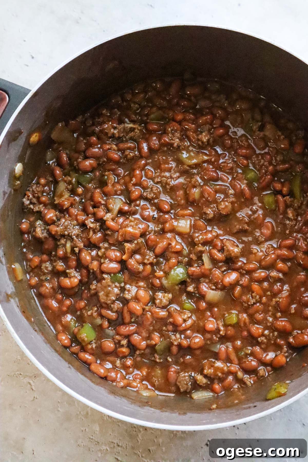 pot with cooked baked beans and ground beef.