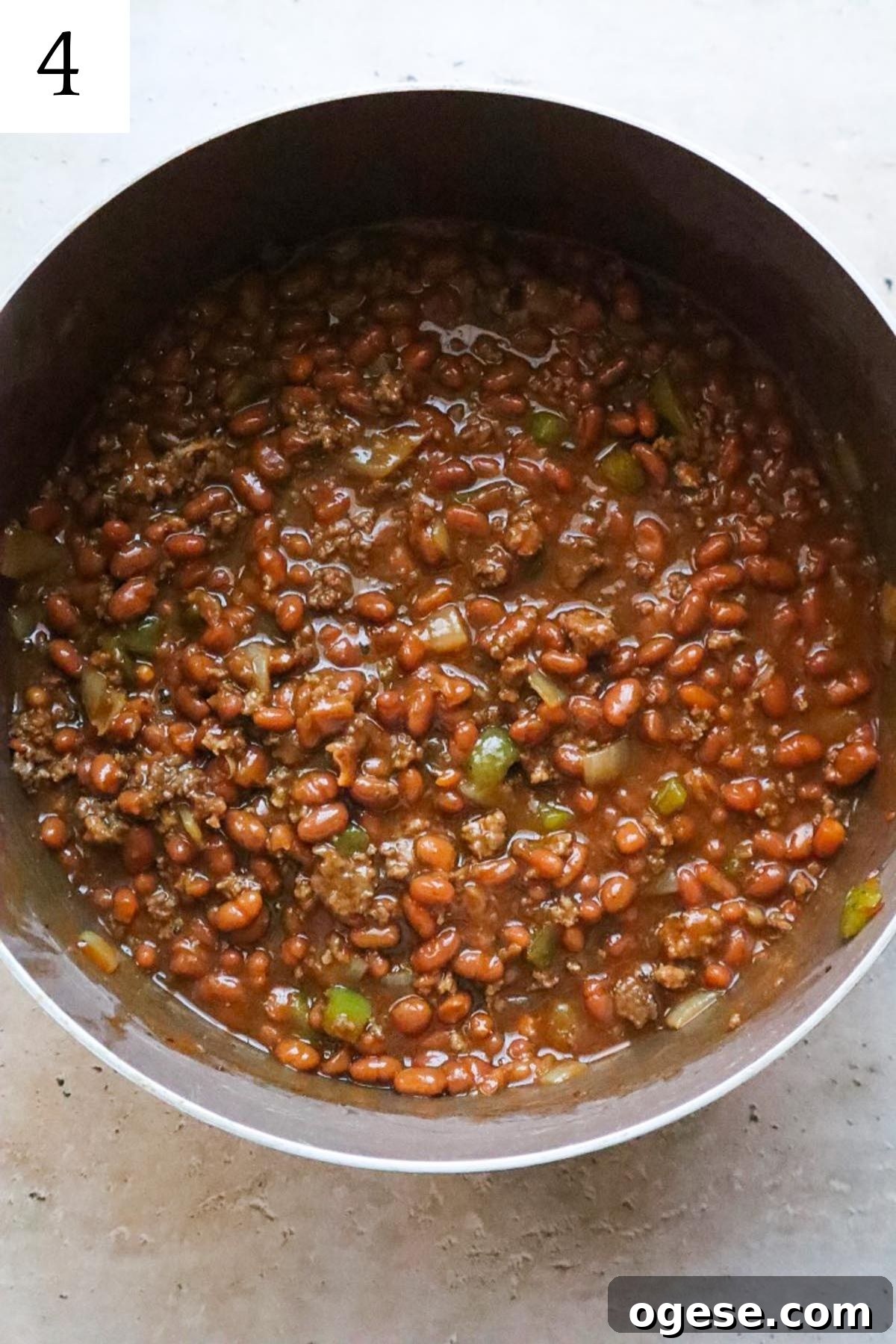 pot with cooked baked beans and ground beef.