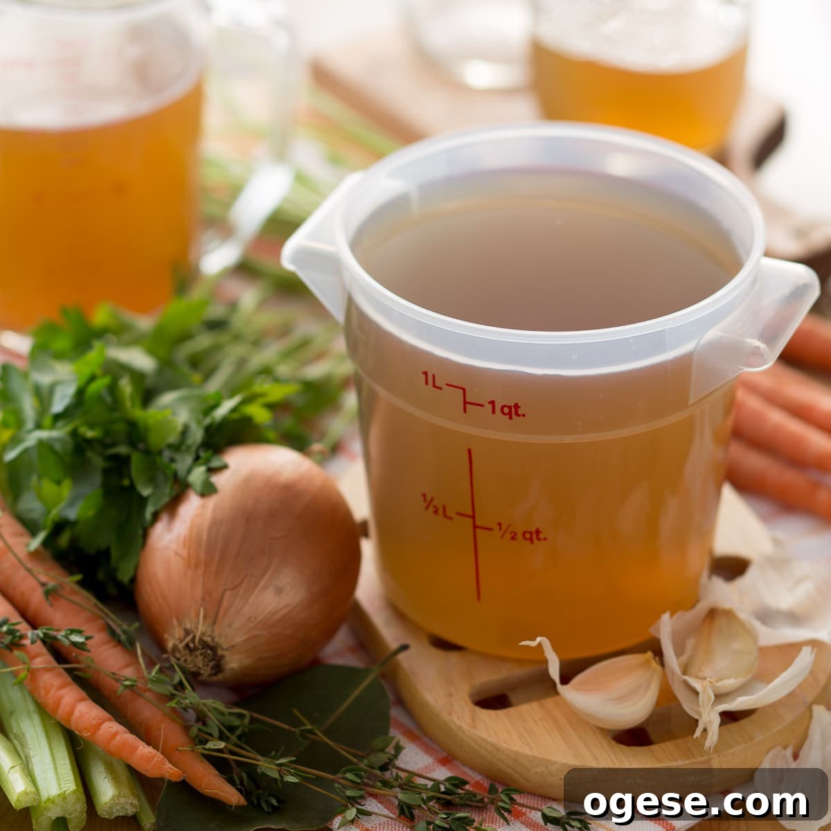 Tuscan White Bean Soup Recipe with Garlic and Kale 9 Golden homemade broth in a quart container.