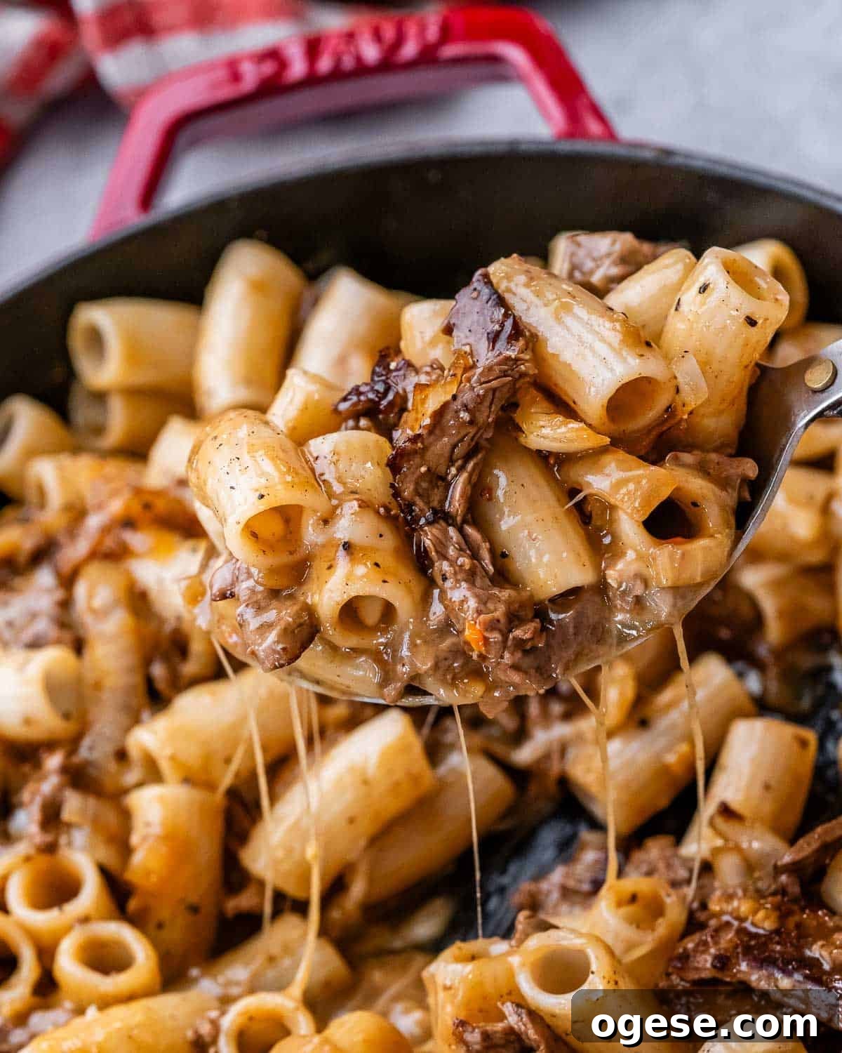 Creamy Philly Cheesesteak Pasta with Peppers & Onions 2 A spoonful of Philly cheesesteak pasta with melted provolone